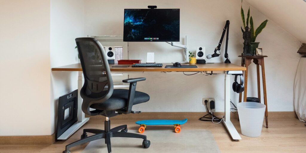 a desk with a computer on top of it